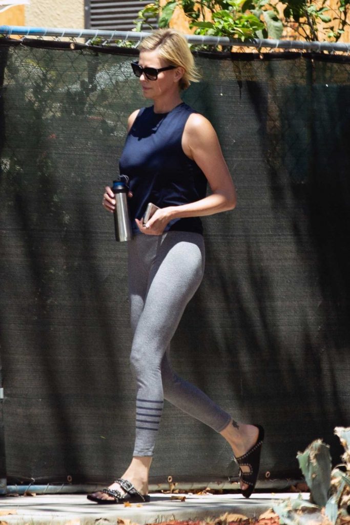Charlize Theron in a Gray Leggings