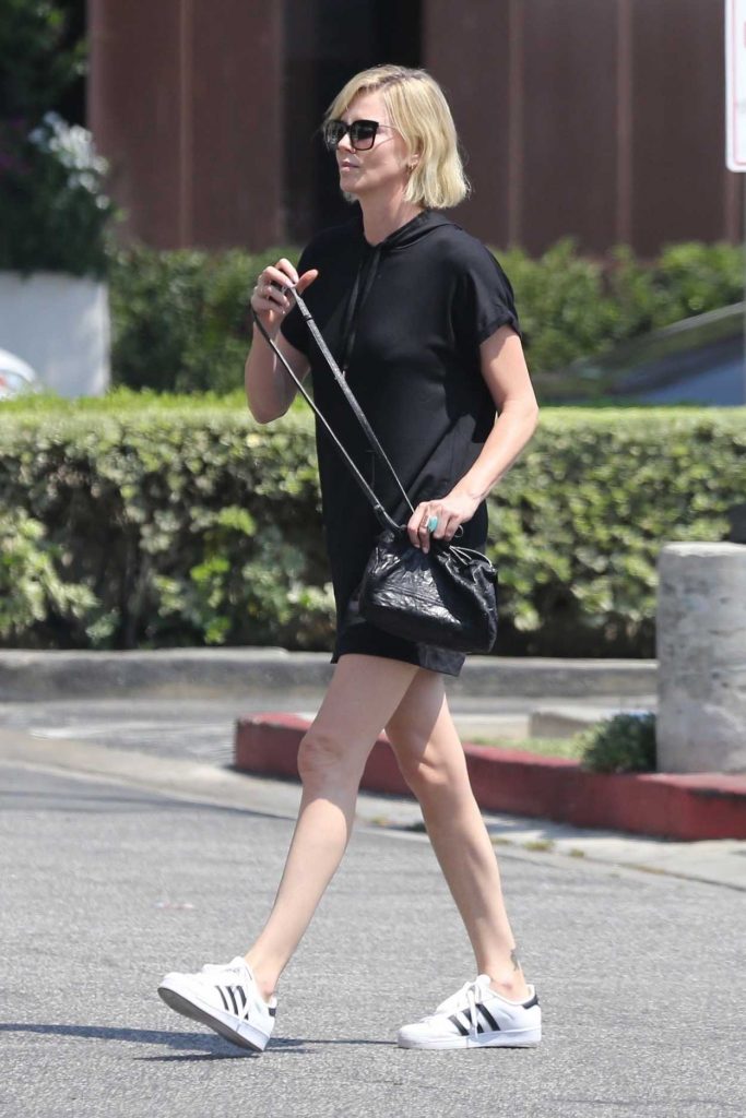 Charlize Theron in a White Adidas Superstar Sneakers
