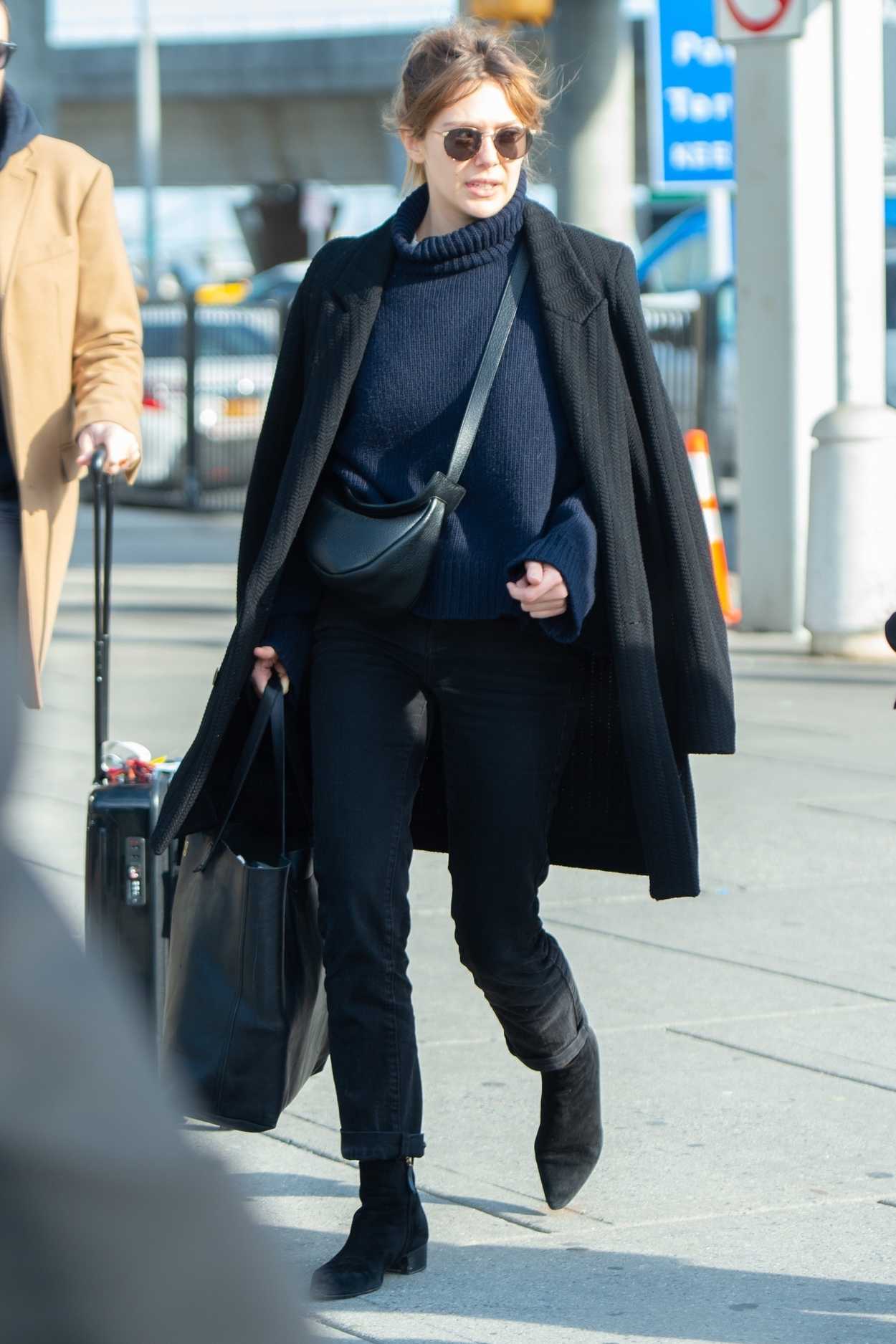 Elizabeth Olsen in a Black Coat Arrives at JFK Airport in NYC 02/15 ...