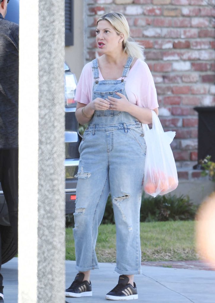 Tori Spelling in a Blue Ripped Overalls