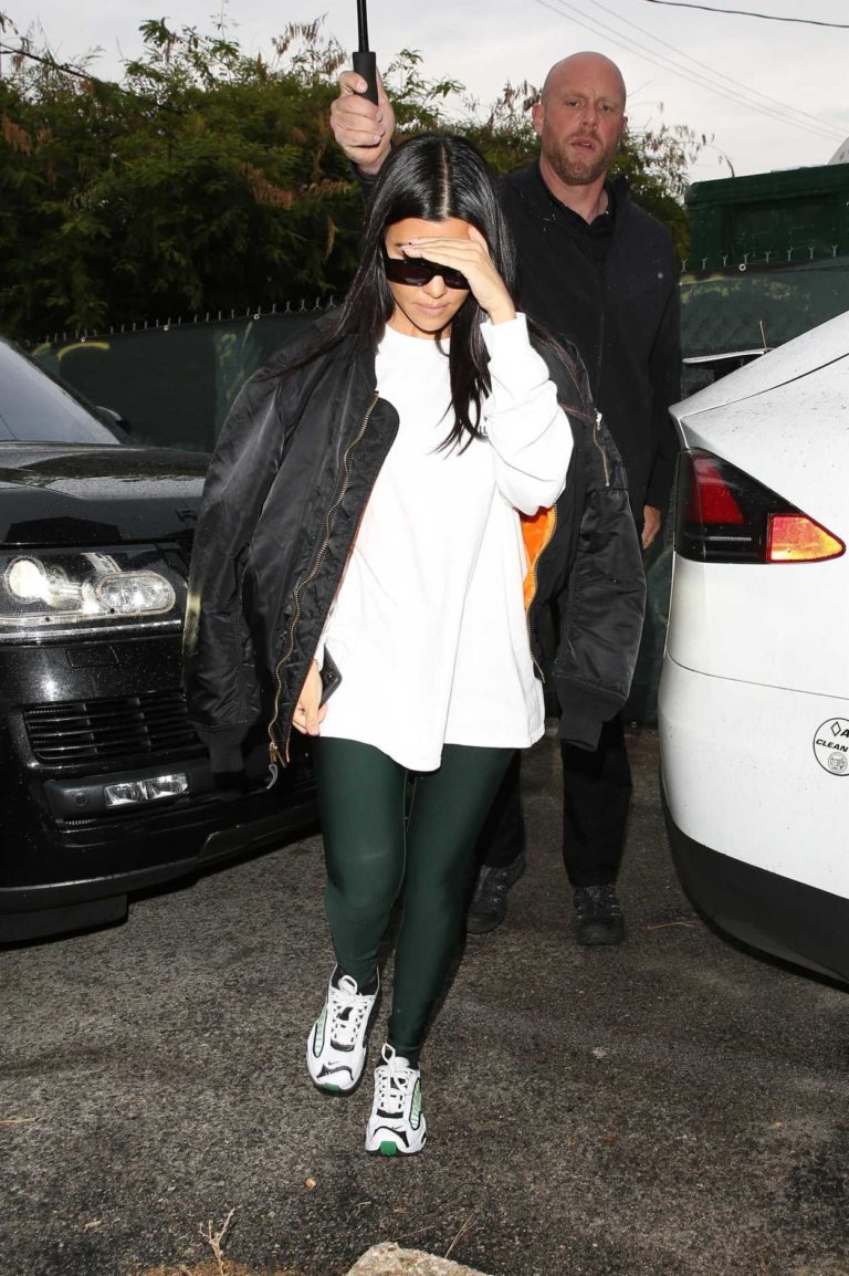 Kourtney Kardashian in a Black Bomber Jacket Arrives at a