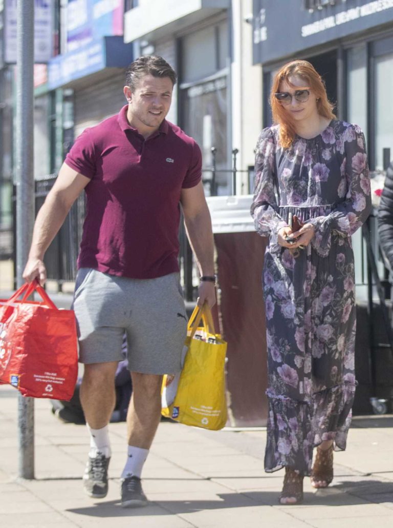 Eleanor Tomlinson in a Black Floral Dress Goes Shopping Out with Her