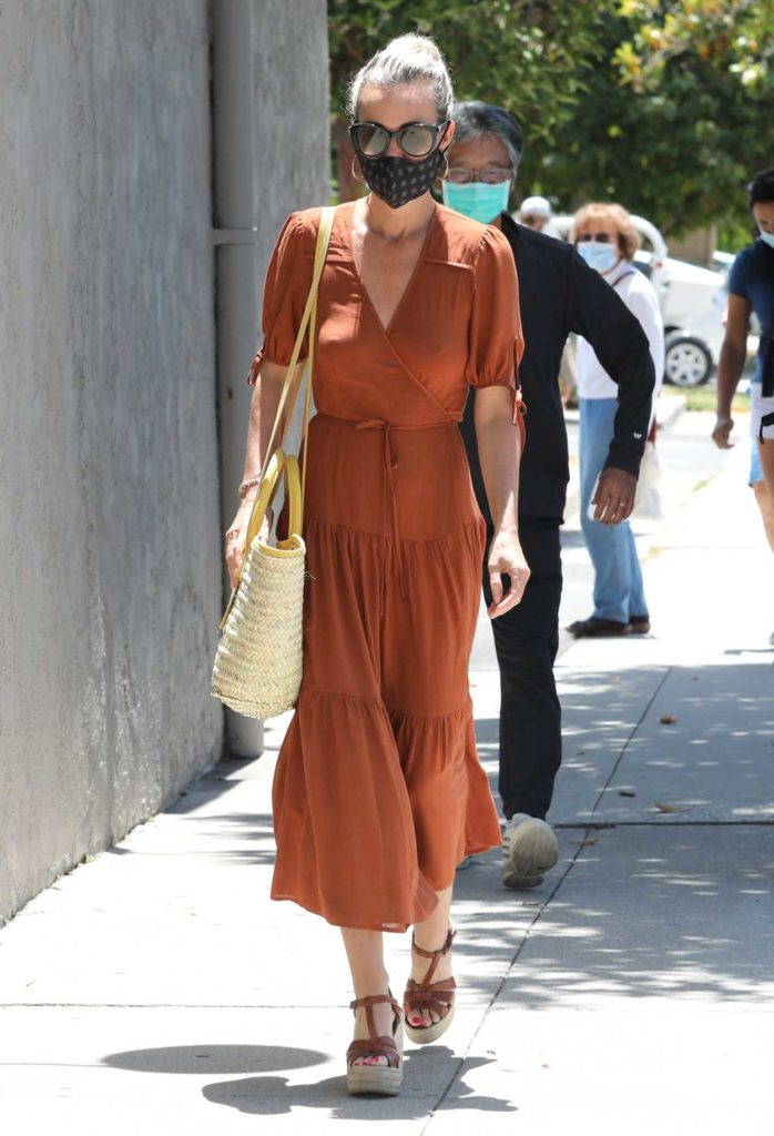 Laeticia Hallyday in a Tan Dress