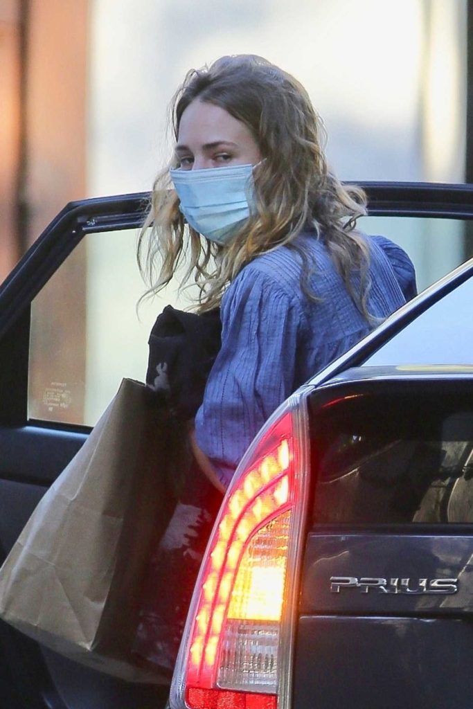 Britt Robertson in a Protective Mask