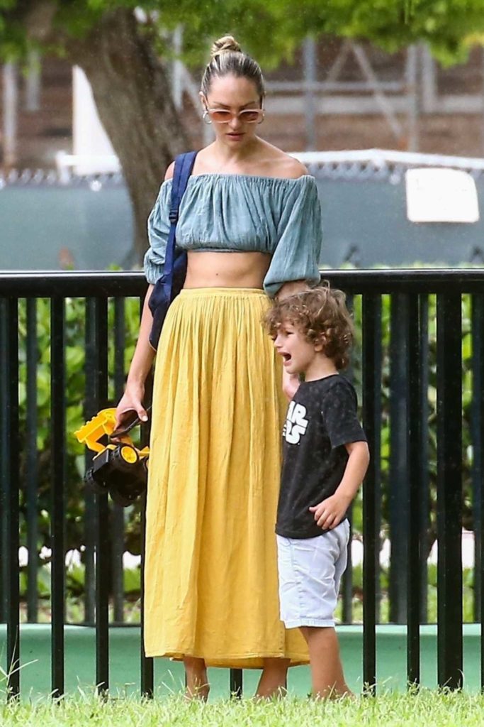Candice Swanepoel in a Yellow Skirt