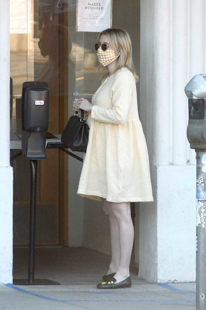 Emma Roberts in a Beige Dress