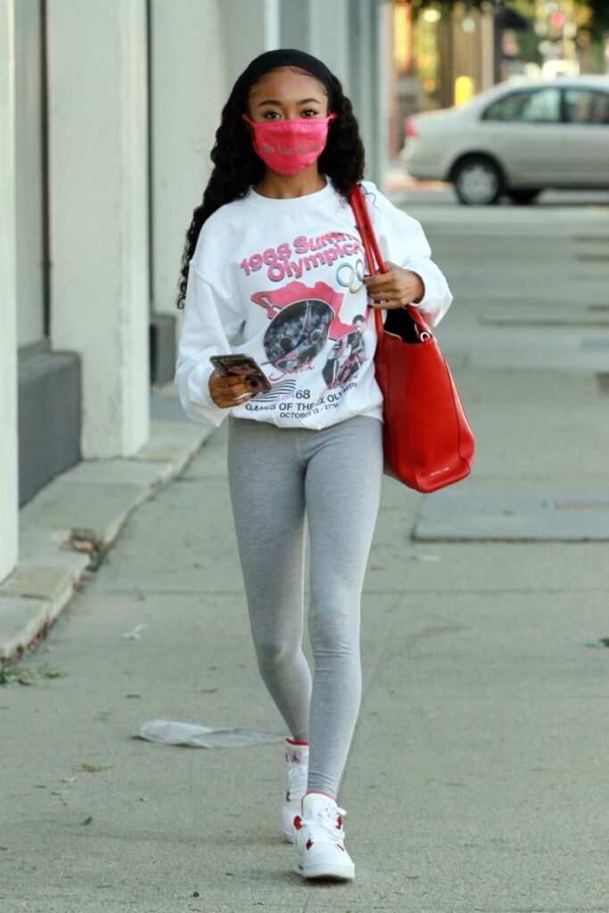 Skai Jackson in a Red Protective Mask