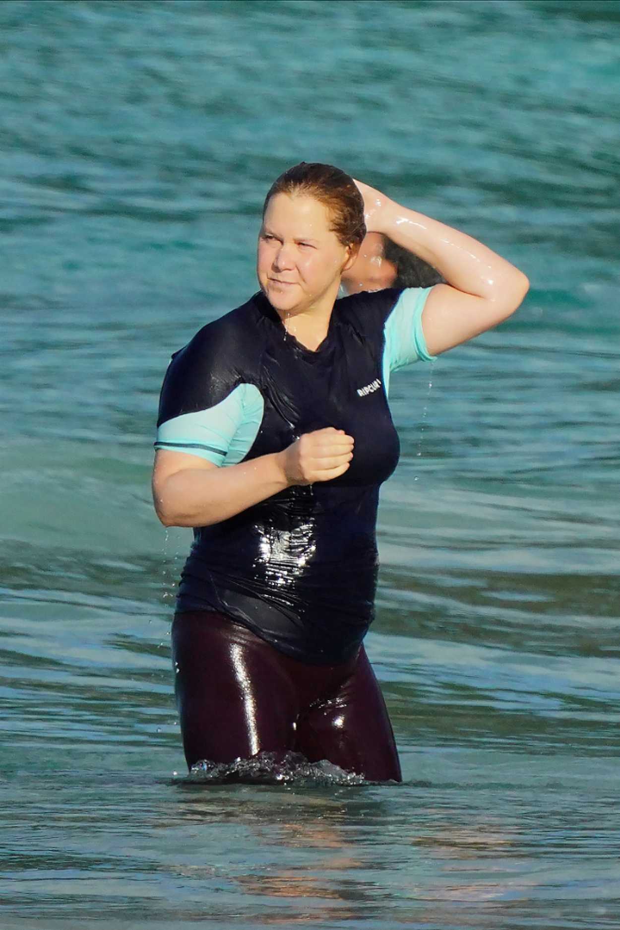 Amy Schumer in a Black Swimsuit Enjoys a Day on the Beach in St. Barths