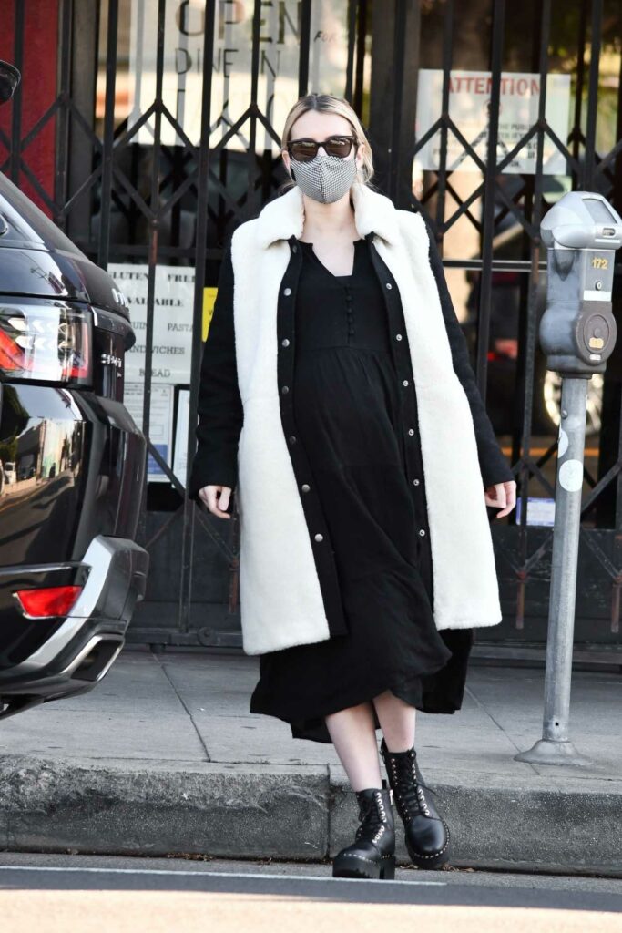 Emma Roberts in a Grey Protective Mask