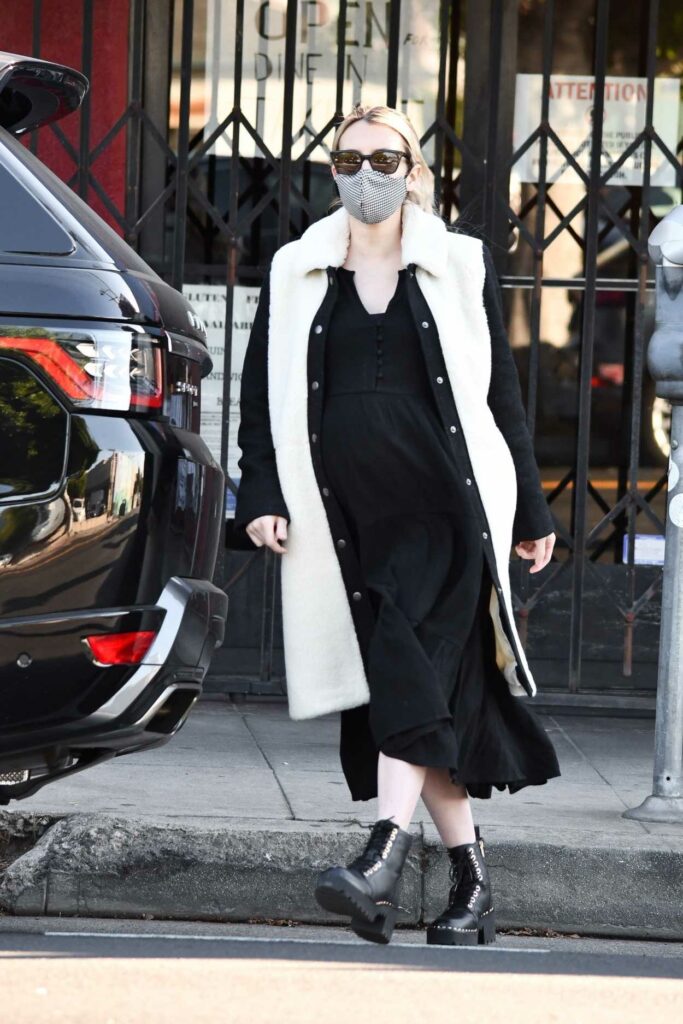 Emma Roberts in a Grey Protective Mask