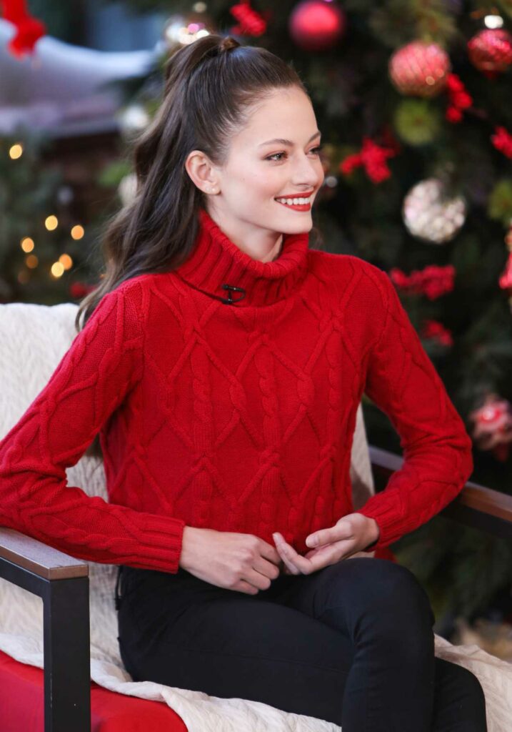 Mackenzie Foy in a Red Knit Turtleneck Visits Hallmark Channel’s Home