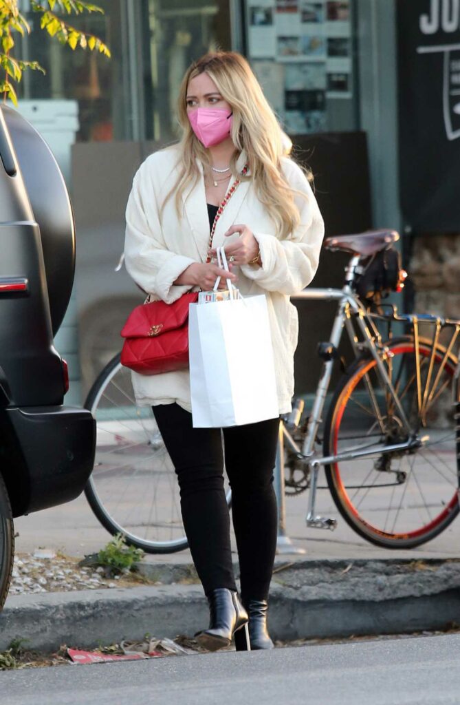 Hilary Duff in a Pink Protective Mask