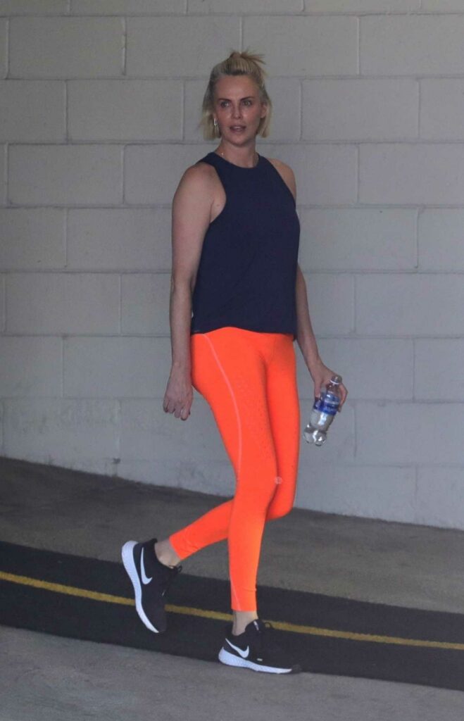 Charlize Theron in an Orange Leggings