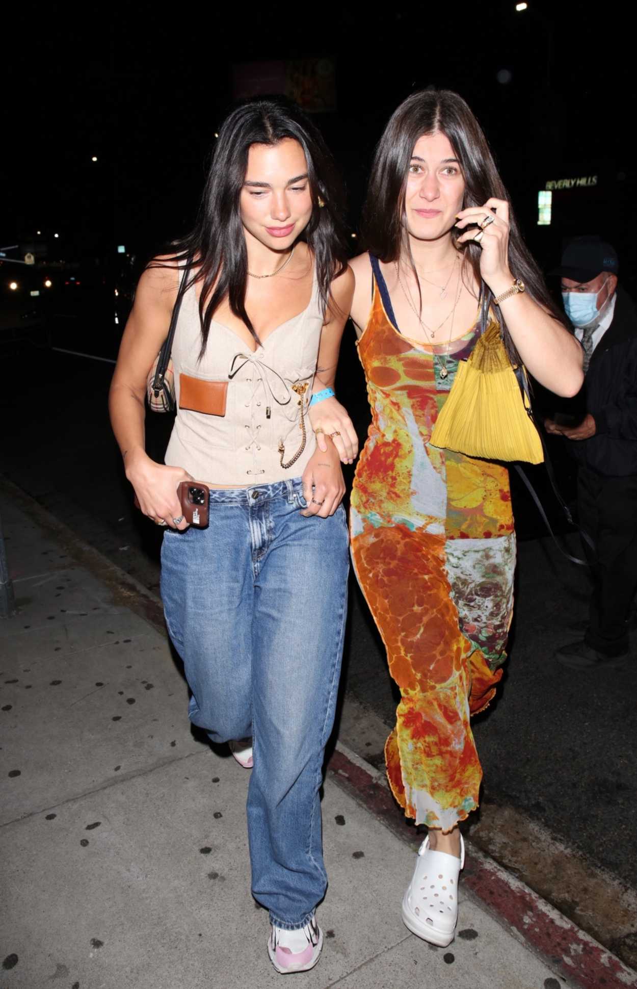 Dua Lipa in a Beige Top Arrives Out with Friend at The Nice Guy in West