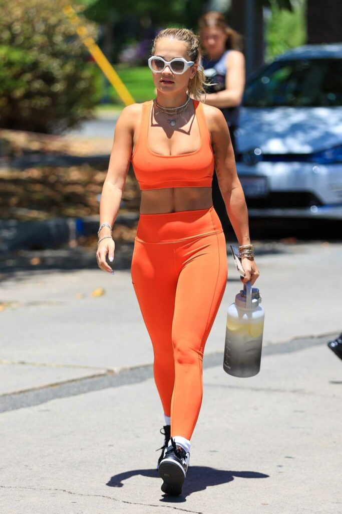 Rita Ora in an Orange Workout Ensemble