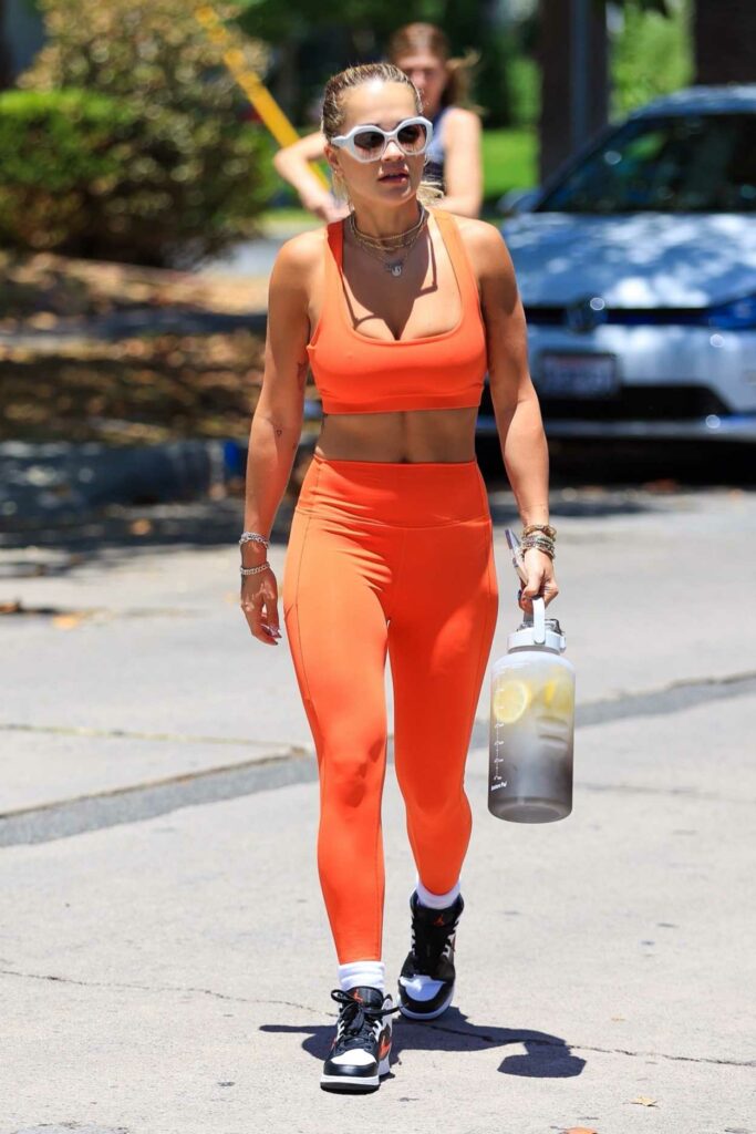 Rita Ora in an Orange Workout Ensemble
