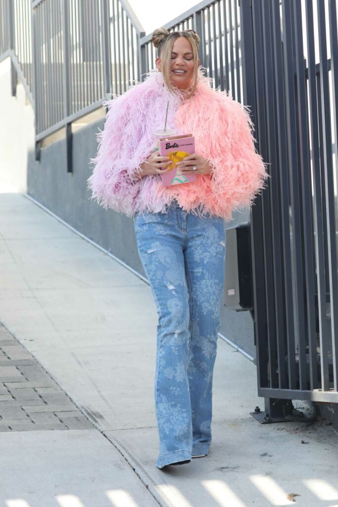 Chrissy Teigen in a Pink Feathered Sweater