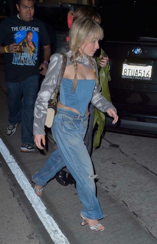 Sabrina Carpenter in a Blue Ripped Jeans