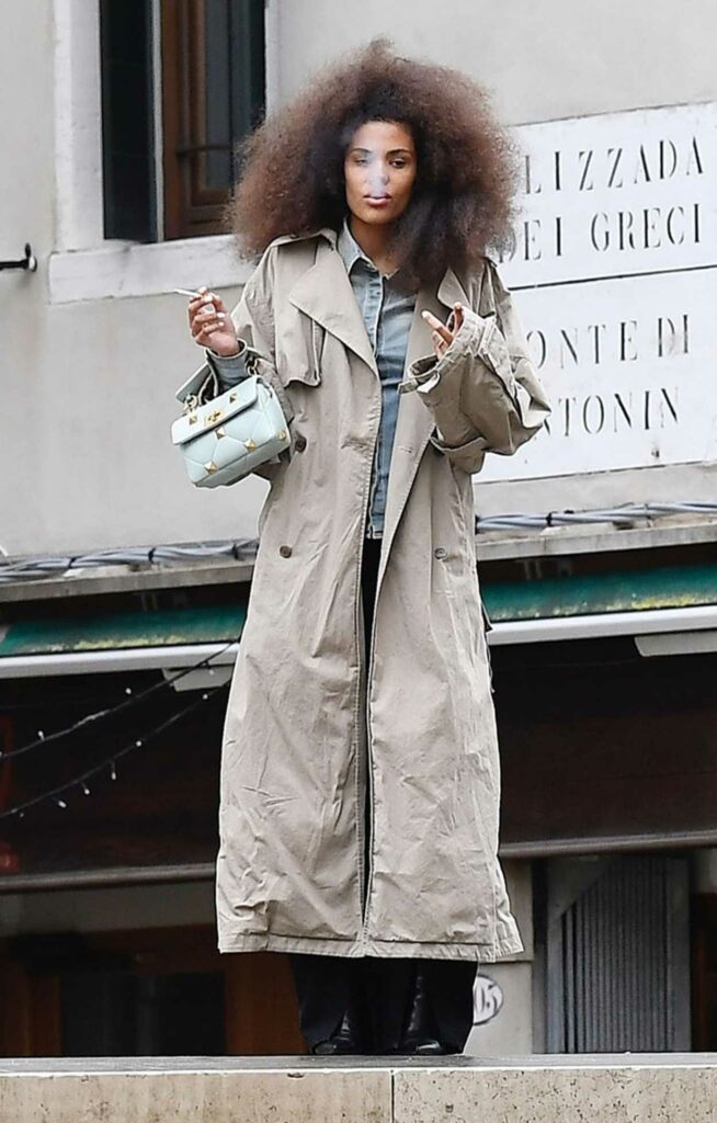 Tina Kunakey in a Beige Trench Coat