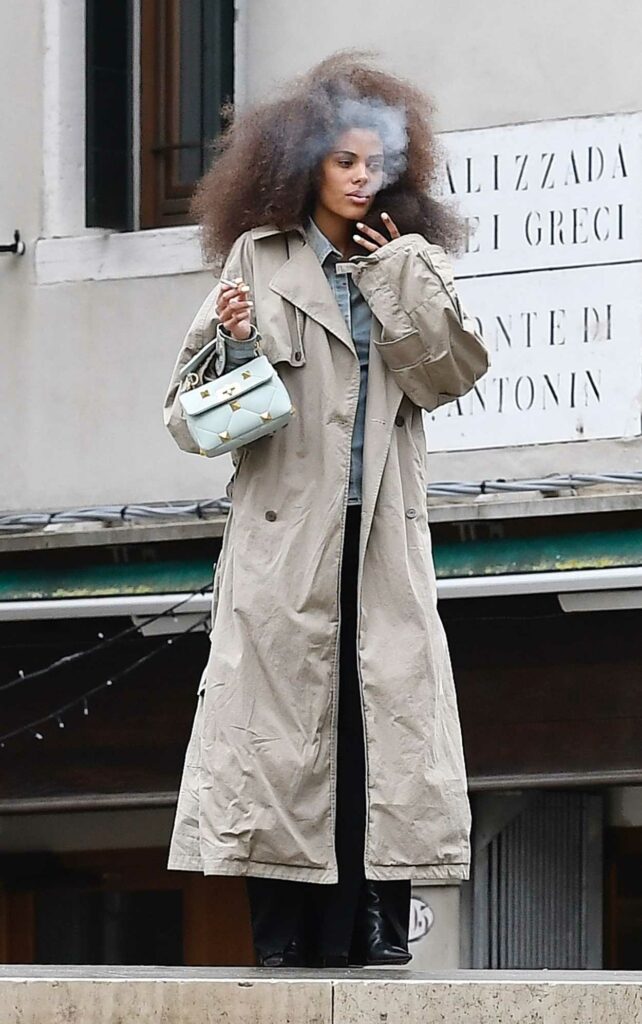 Tina Kunakey in a Beige Trench Coat