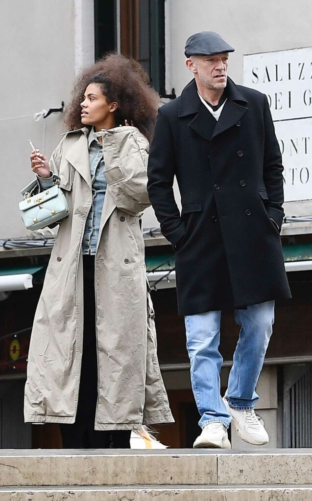 Tina Kunakey in a Beige Trench Coat