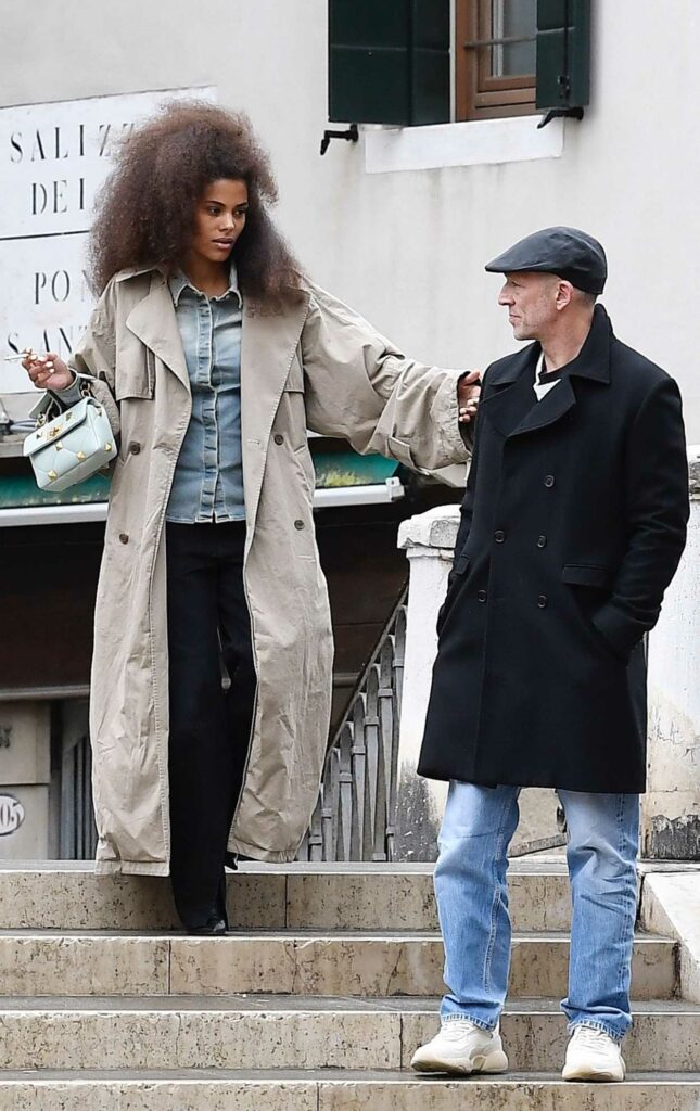 Tina Kunakey in a Beige Trench Coat