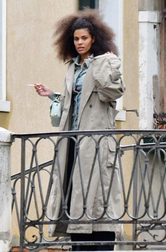 Tina Kunakey in a Beige Trench Coat