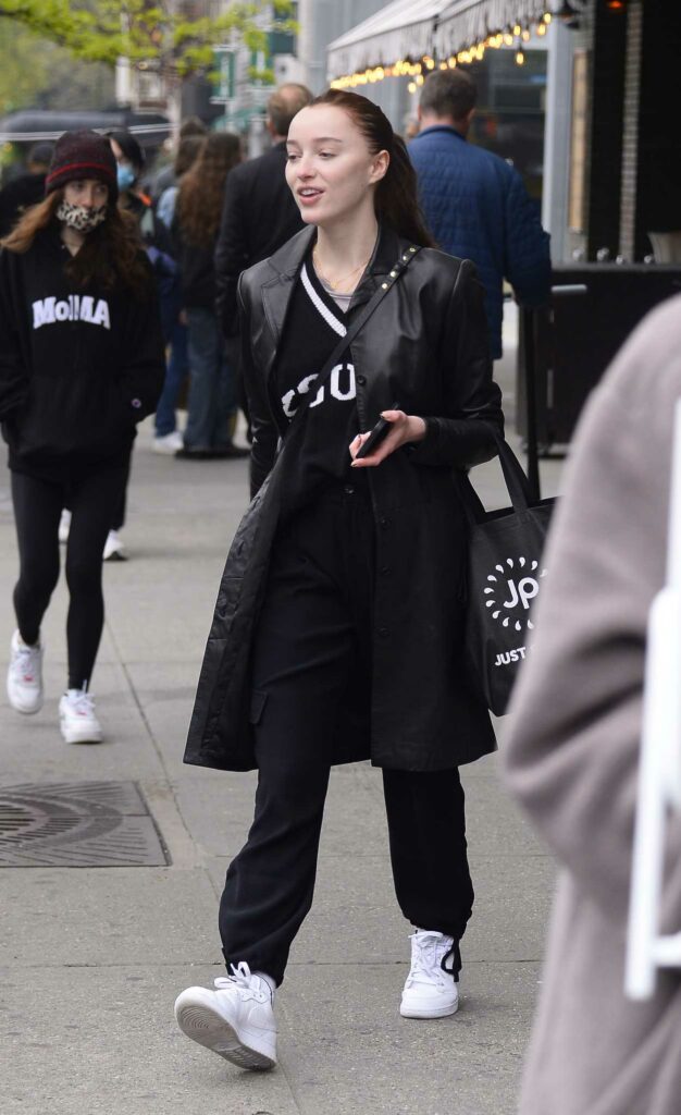 Phoebe Dynevor in a Black Leather Trench Coat