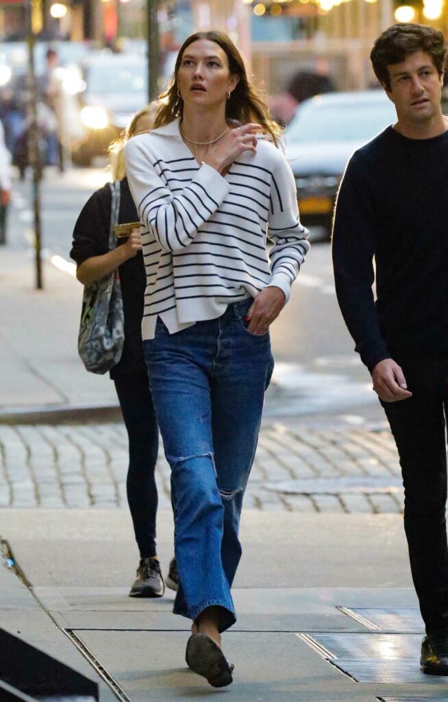 Karlie Kloss in a White Striped Blouse