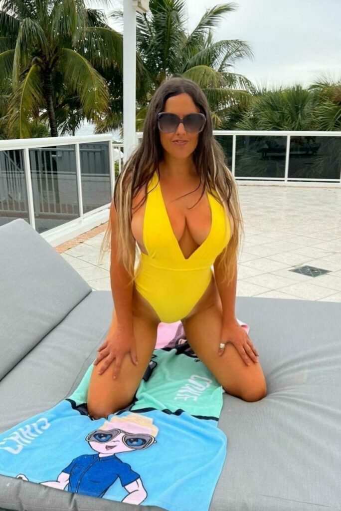 Claudia Romani in an Orange Swimsuit