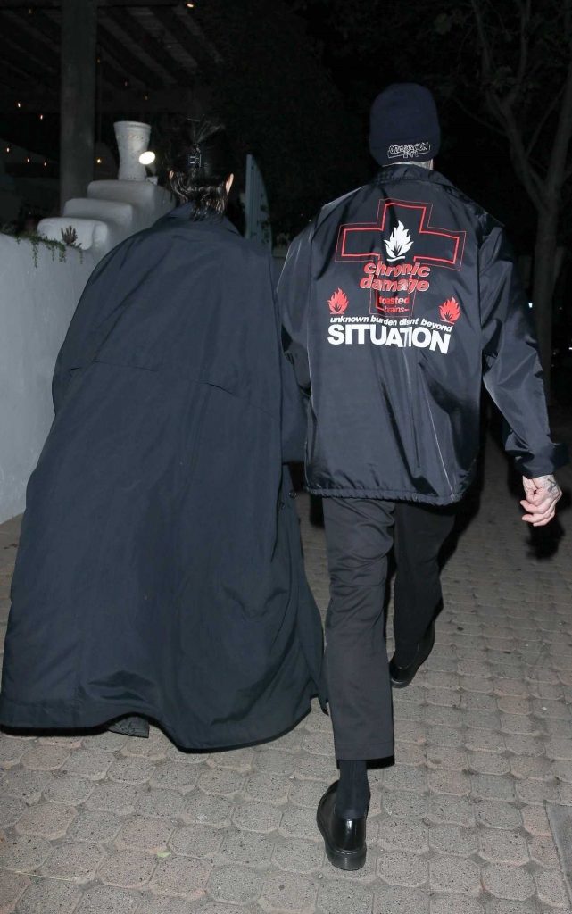 Kourtney Kardashian in a Black Trench Coat
