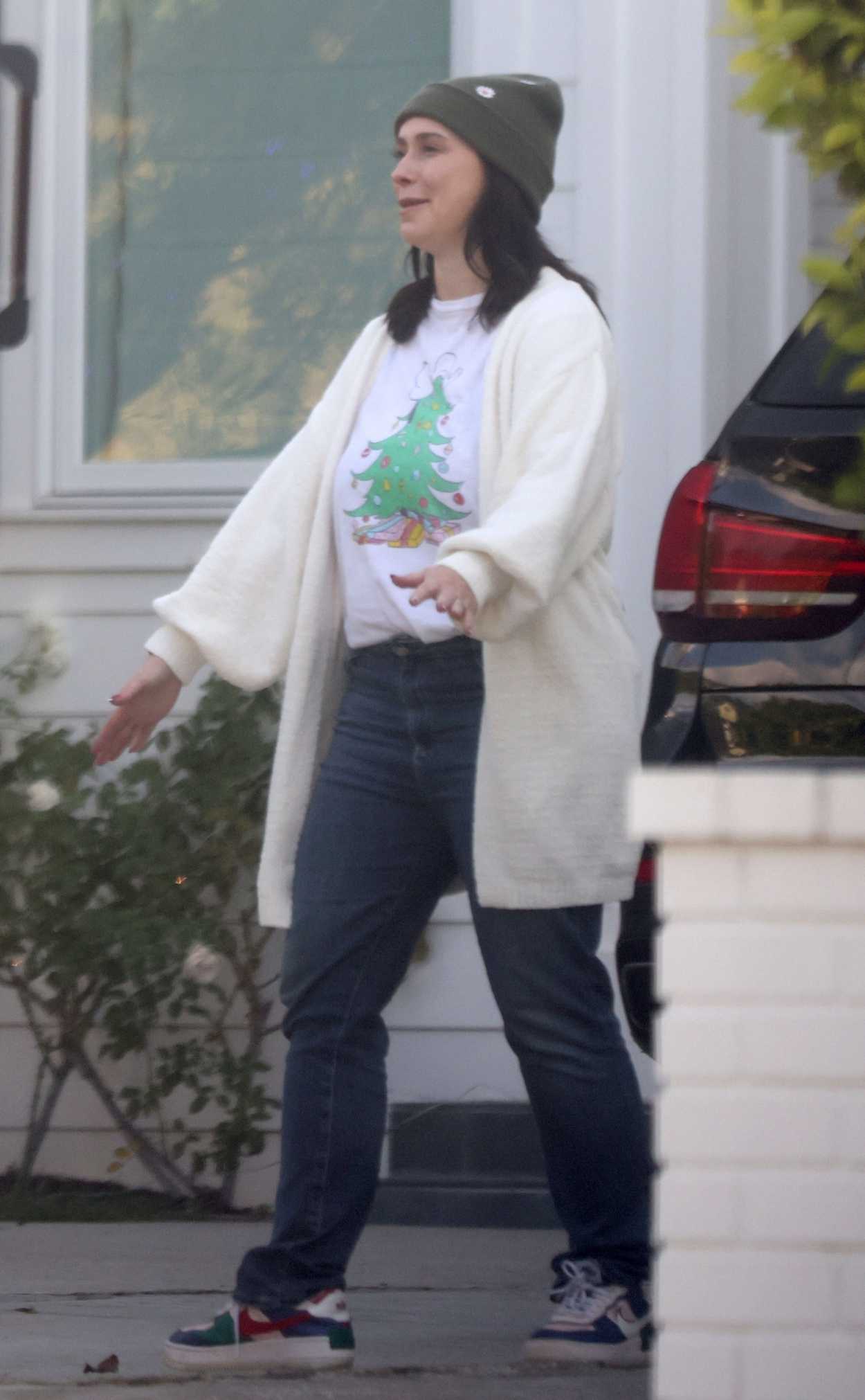 Jennifer Love Hewitt in a White Cardigan Arrives at a Christmas Eve ...