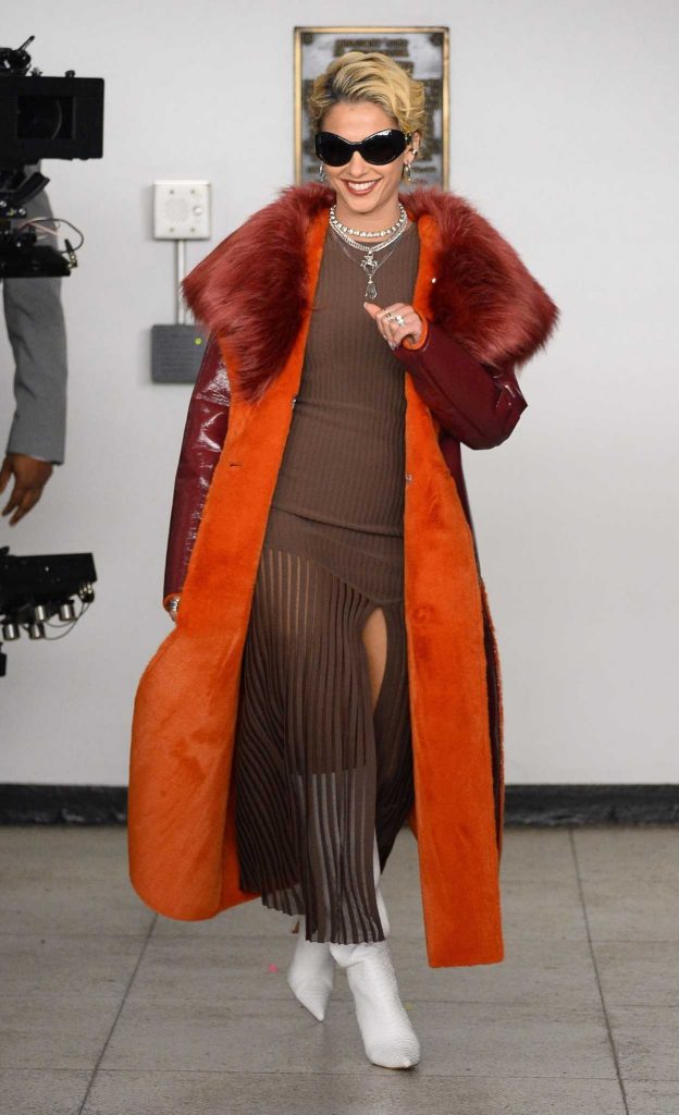 Naomi Scott in a Red Leather Coat