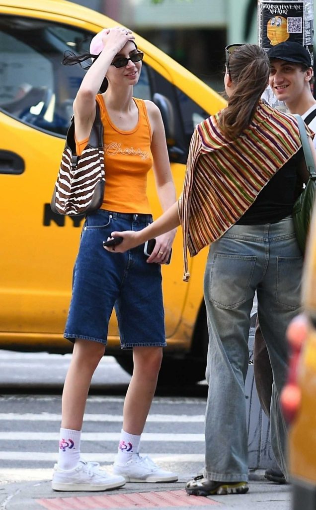 Meadow Walker in an Orange Tank Top