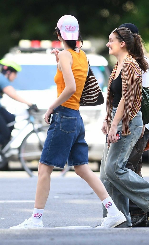 Meadow Walker in an Orange Tank Top