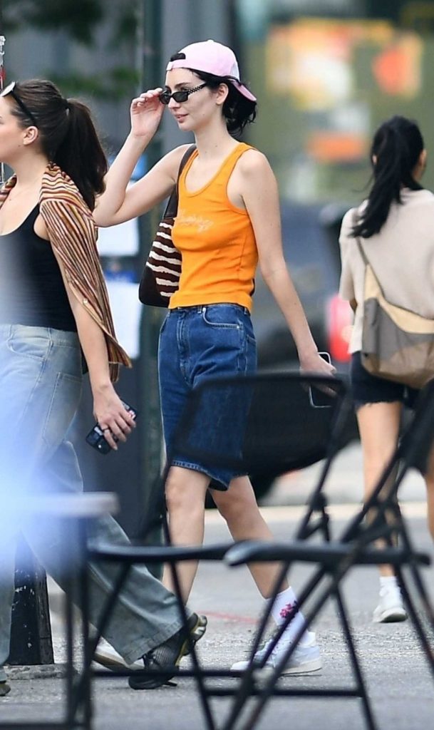 Meadow Walker in an Orange Tank Top