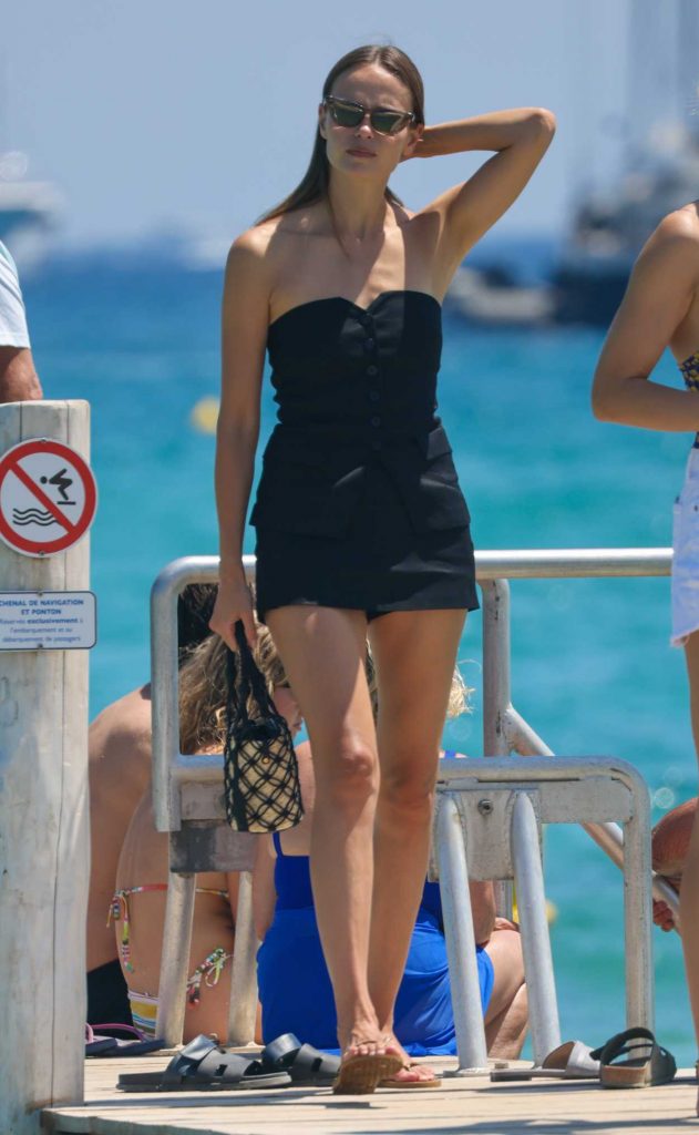 Natasha Poly in a Black Strapless Mini Dress