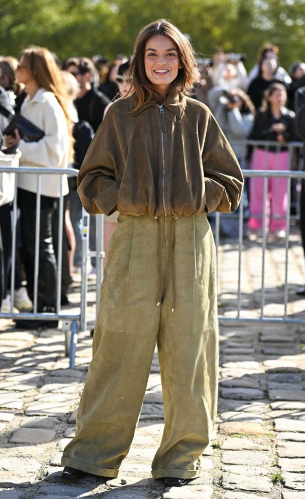 Emma Mackey in a Brown Jacket