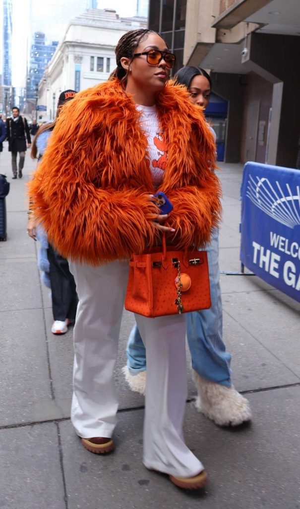 Jordyn Woods in an Orange Fur Jacket