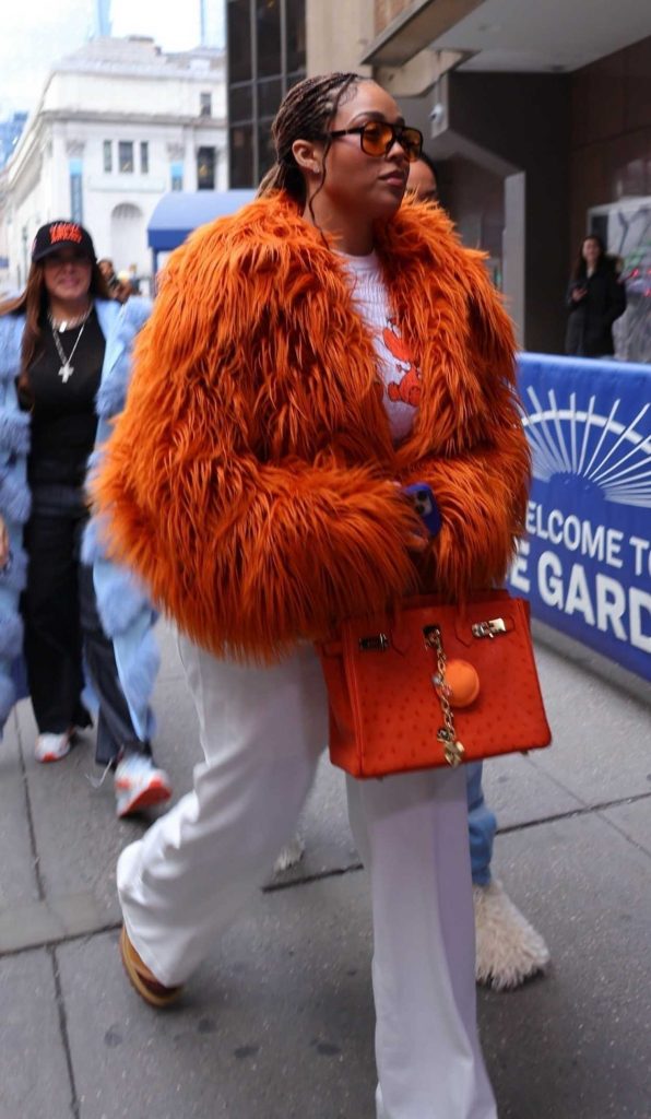 Jordyn Woods in an Orange Fur Jacket