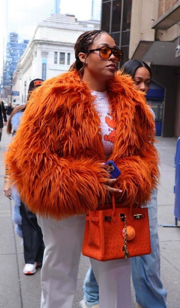 Jordyn Woods in an Orange Fur Jacket