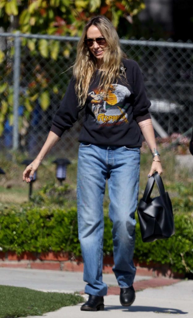 Tish Cyrus in a Black Sweatshirt