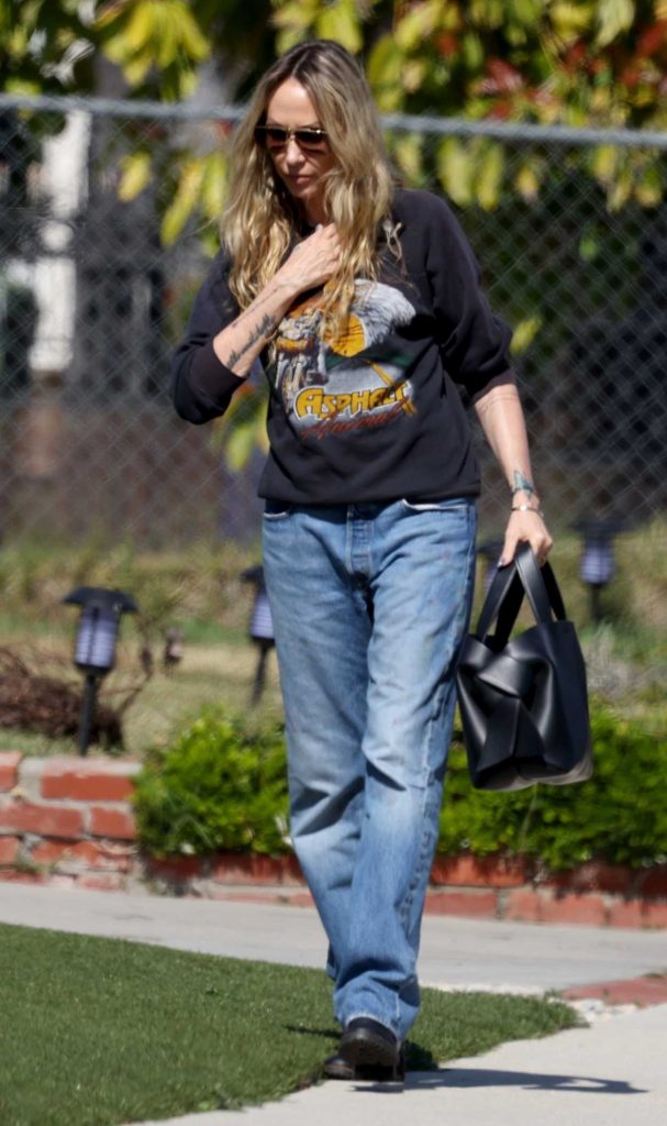 Tish Cyrus in a Black Sweatshirt