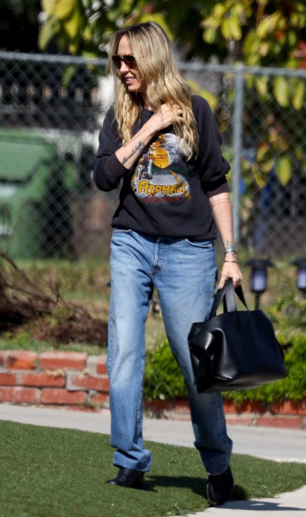 Tish Cyrus in a Black Sweatshirt