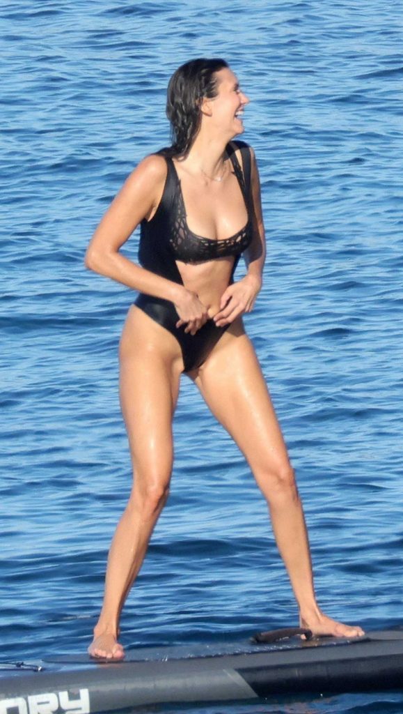 Nina Dobrev in a Black Swimsuit