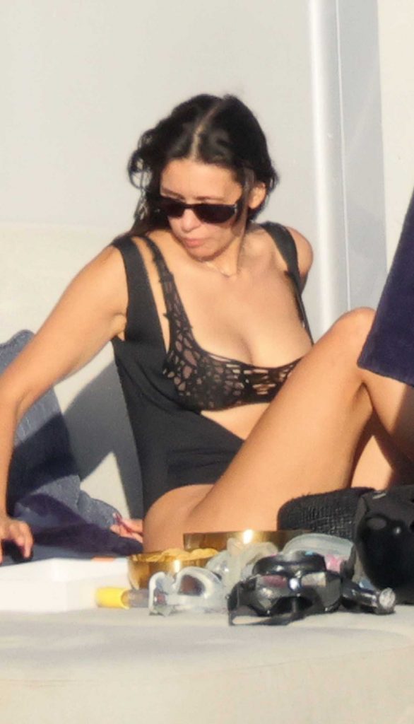 Nina Dobrev in a Black Swimsuit