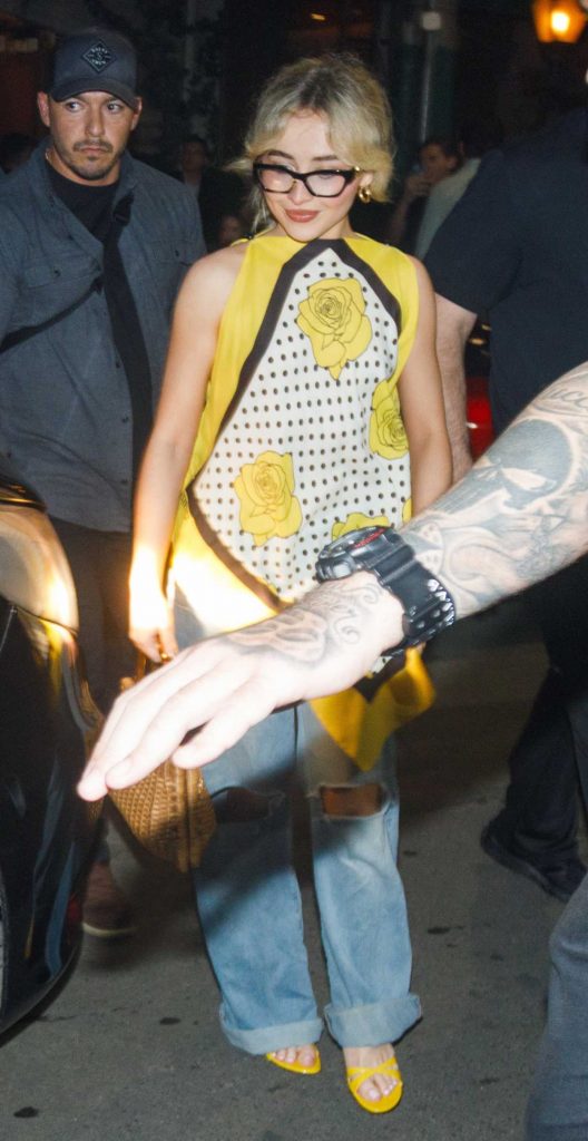 Sabrina Carpenter in a Blue Ripped Jeans