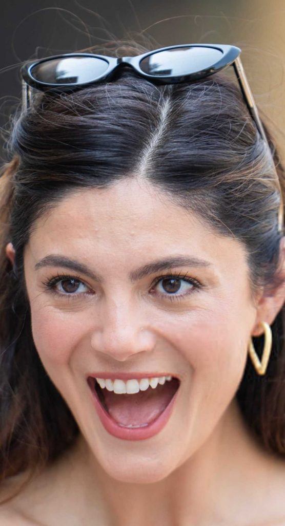 Monica Barbaro in a Red Top