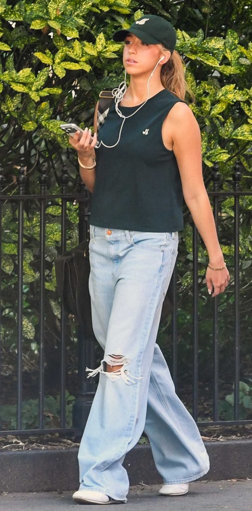 Tate McRae in a Blue Ripped Jeans