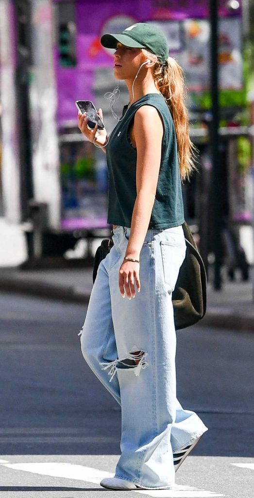 Tate McRae in a Blue Ripped Jeans